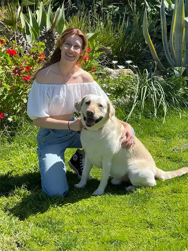 Jess posing with her yellow lab, Orion